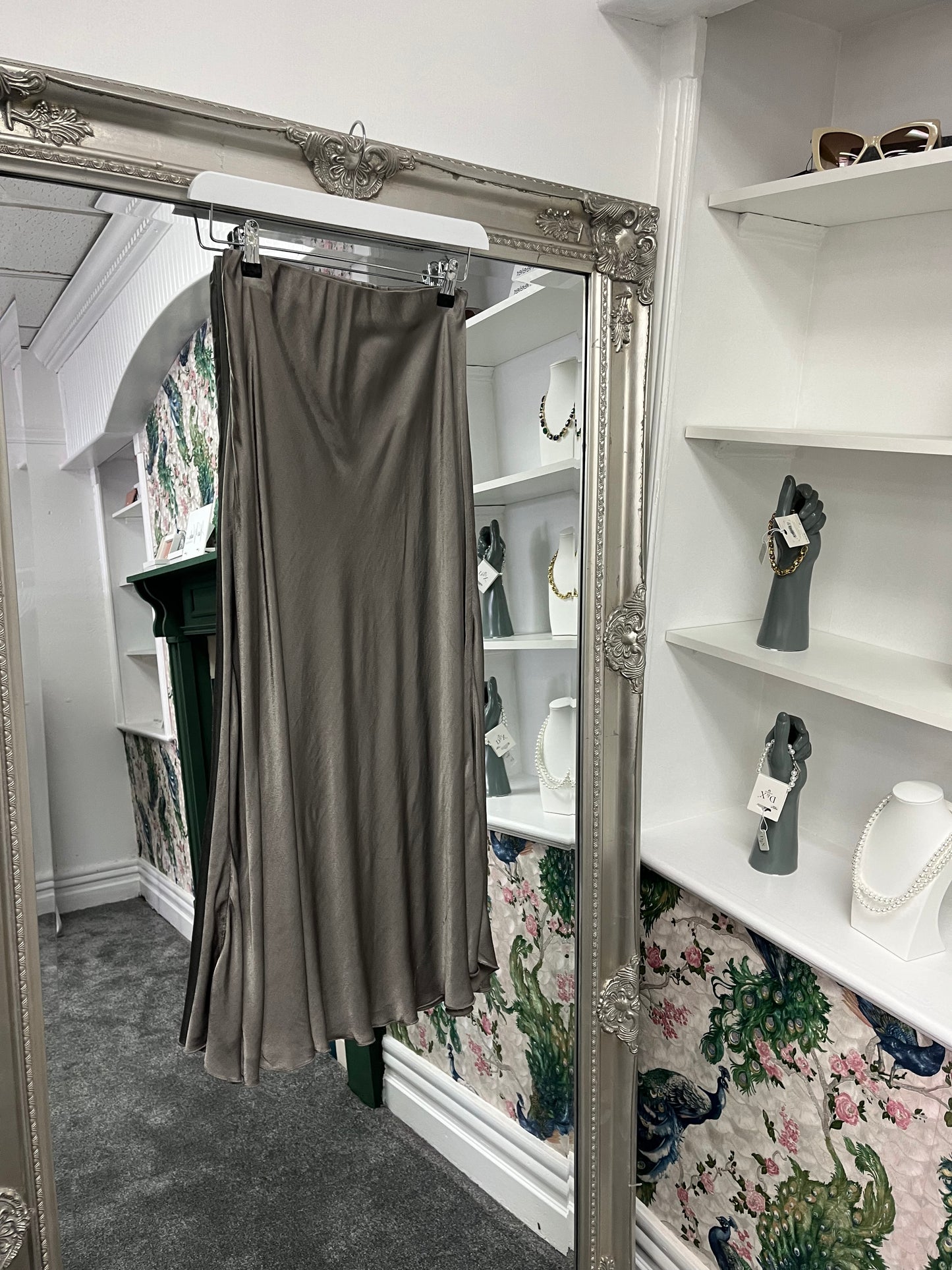 Elegant silver silky skirt with a smooth, flowing fabric, designed to fit sizes 8-14/16 for a flattering, versatile look.