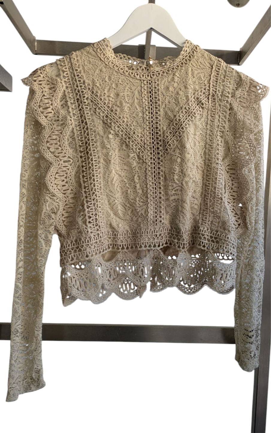 Stylish long-sleeved cropped top in a versatile one-size design, fitting sizes 8-14, with a flattering snug fit.