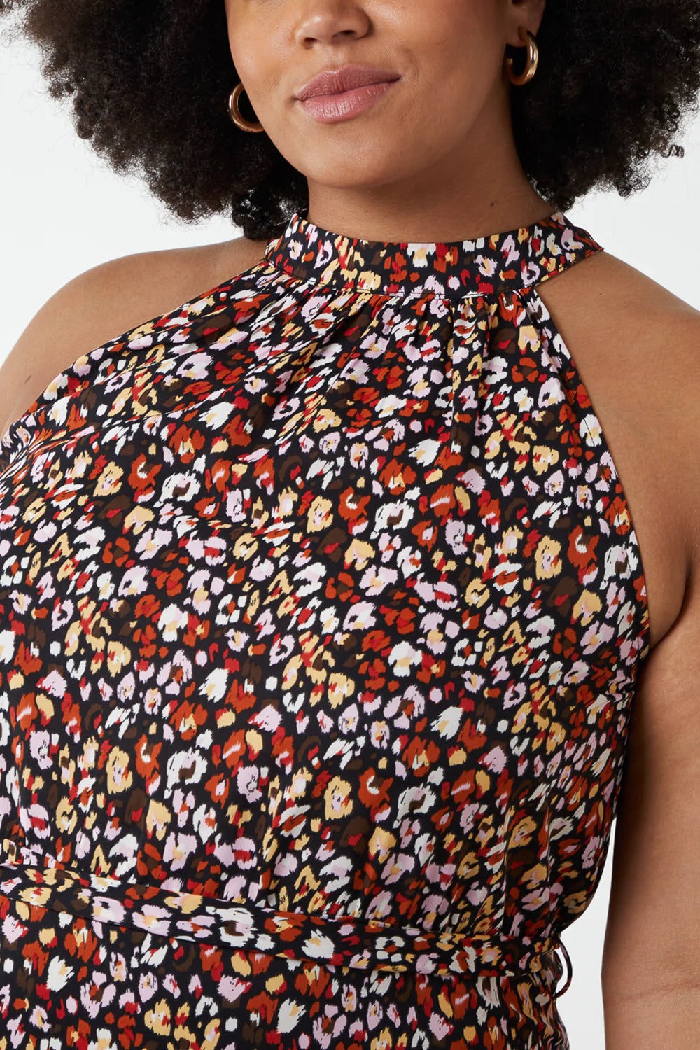 Vibrant leopard print maxi dress with a halter neck design, showcasing a flattering silhouette for plus-size fashion.
