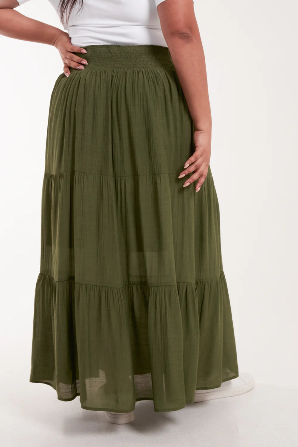 Flowy tiered maxi skirt in a lightweight fabric, featuring a shirred elastic waist for a comfy, flattering fit in plus sizes.