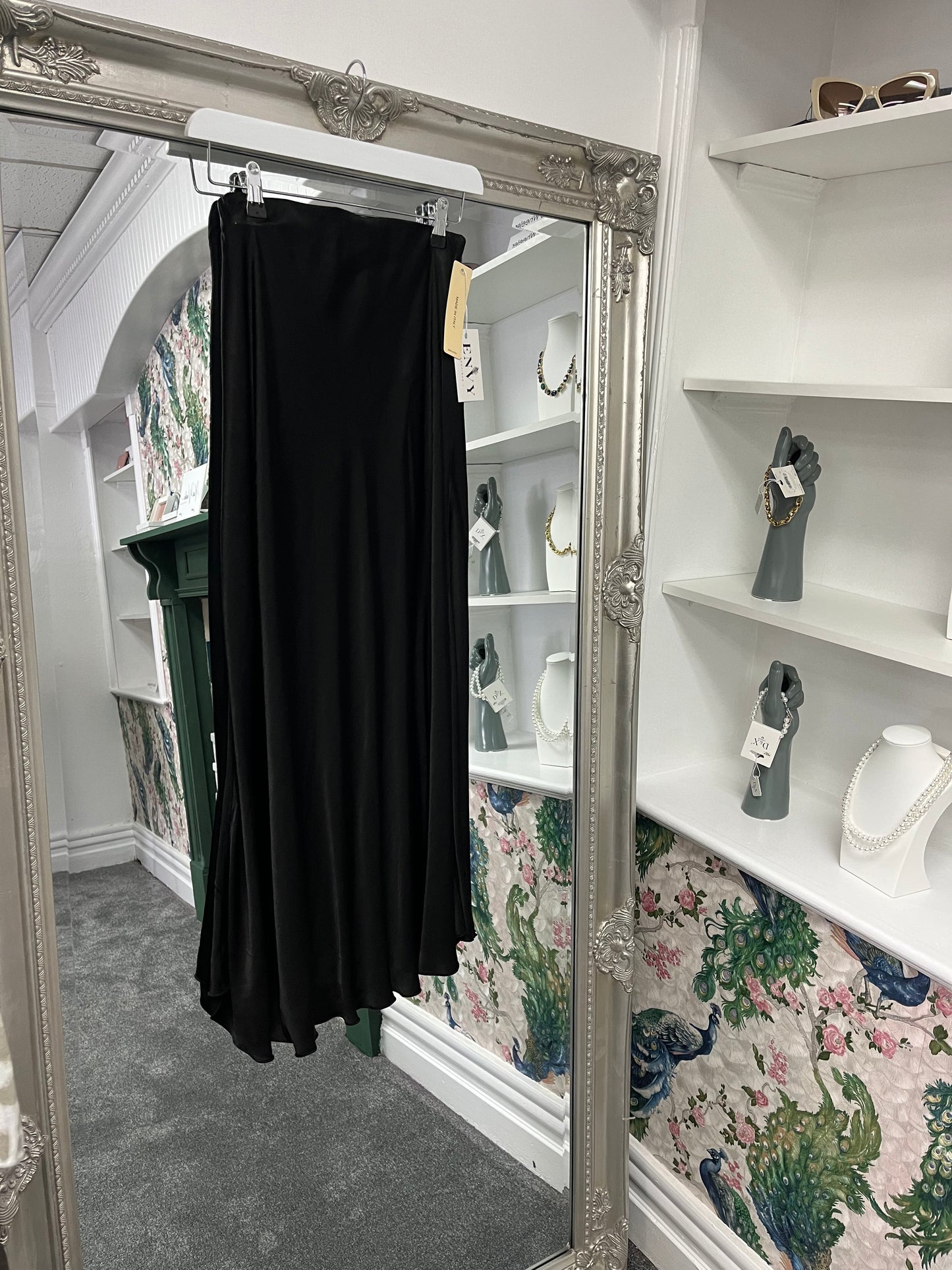 Elegant black silky skirt with a smooth, flowing fabric, designed to fit sizes 8-14/16 for a versatile, chic look.