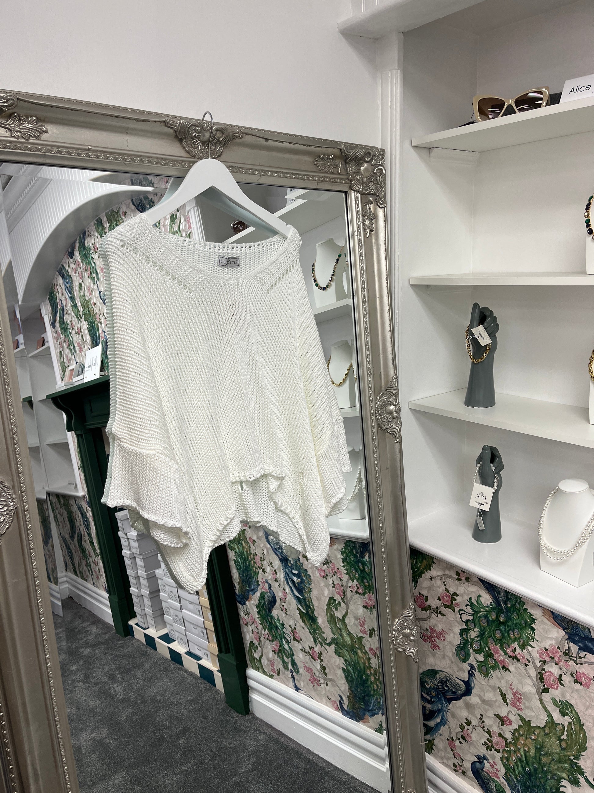 Delicate crochet top with stylish cut-out holes, designed to fit sizes 8-14, showcasing a breezy, textured look.
