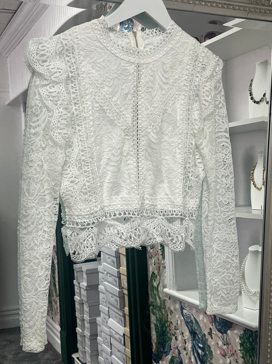 Stylish long-sleeved cropped top from Luxtyle, designed to fit sizes 8-14, with a flattering and versatile silhouette.