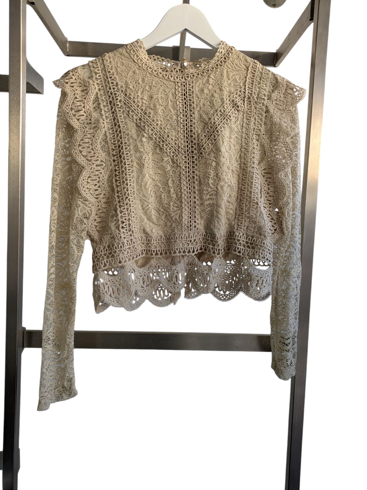 Stylish long-sleeved cropped top in a versatile one-size design, fitting sizes 8-14, perfect for casual or trendy looks.
