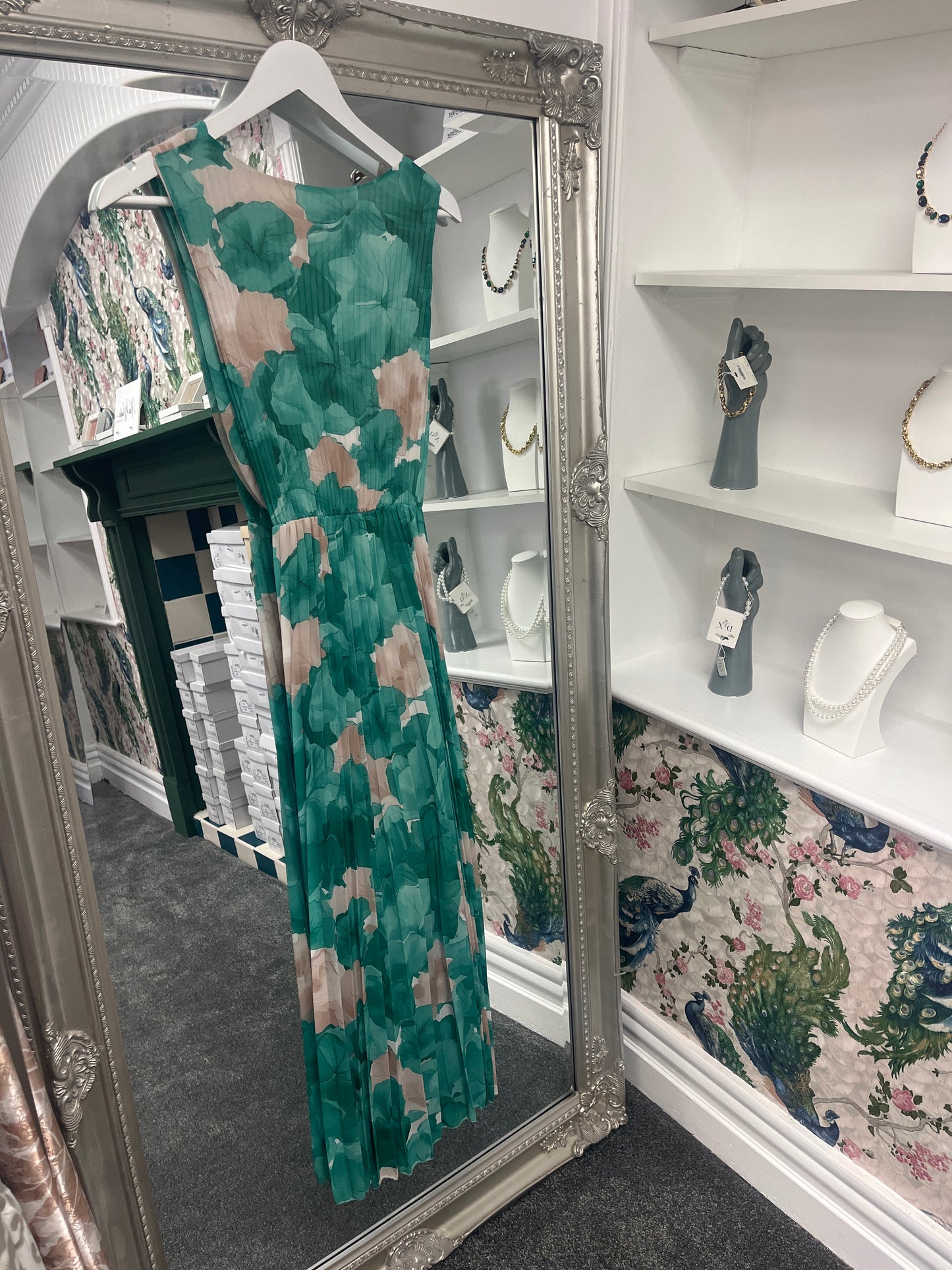 Elegant green pleated floral dress with a flattering fit for sizes 8-14, featuring delicate patterns and soft fabric.
