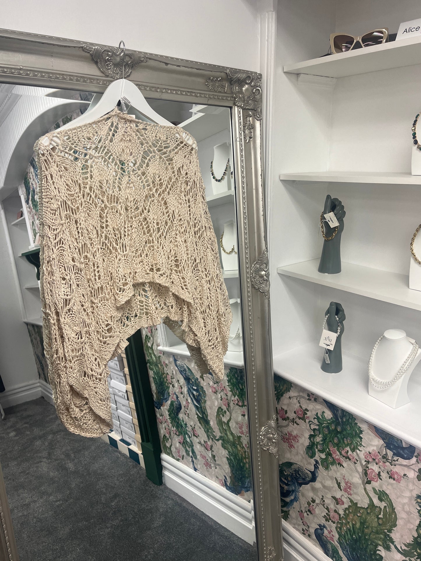 Delicate beige cropped crochet top with intricate patterns, designed to fit sizes 8-18 for a stylish, versatile look.