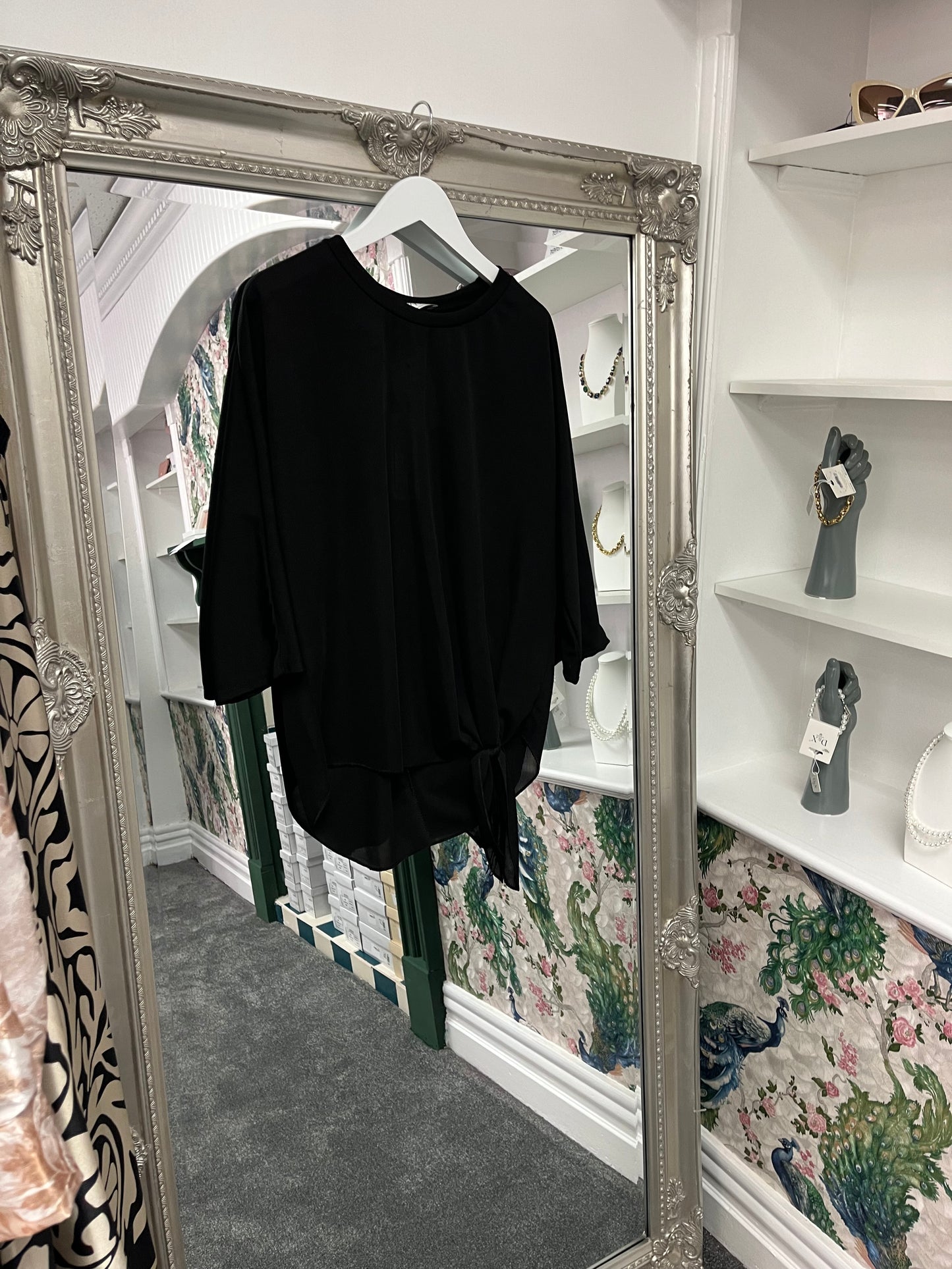 Elegant black front-tie top with a stylish knot at the waist, designed to flatter sizes 8-14 UK with a chic, versatile look.