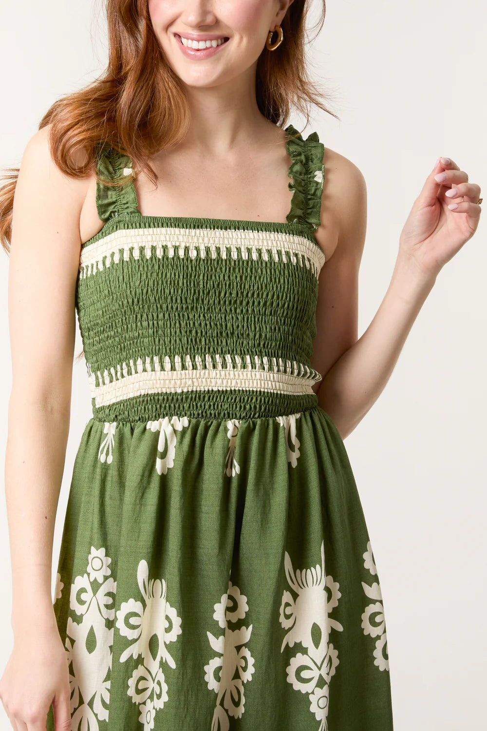 Flowing maxi dress with a shirred bodice and vibrant print, crafted from a soft viscose-polyester blend for all-day comfort.