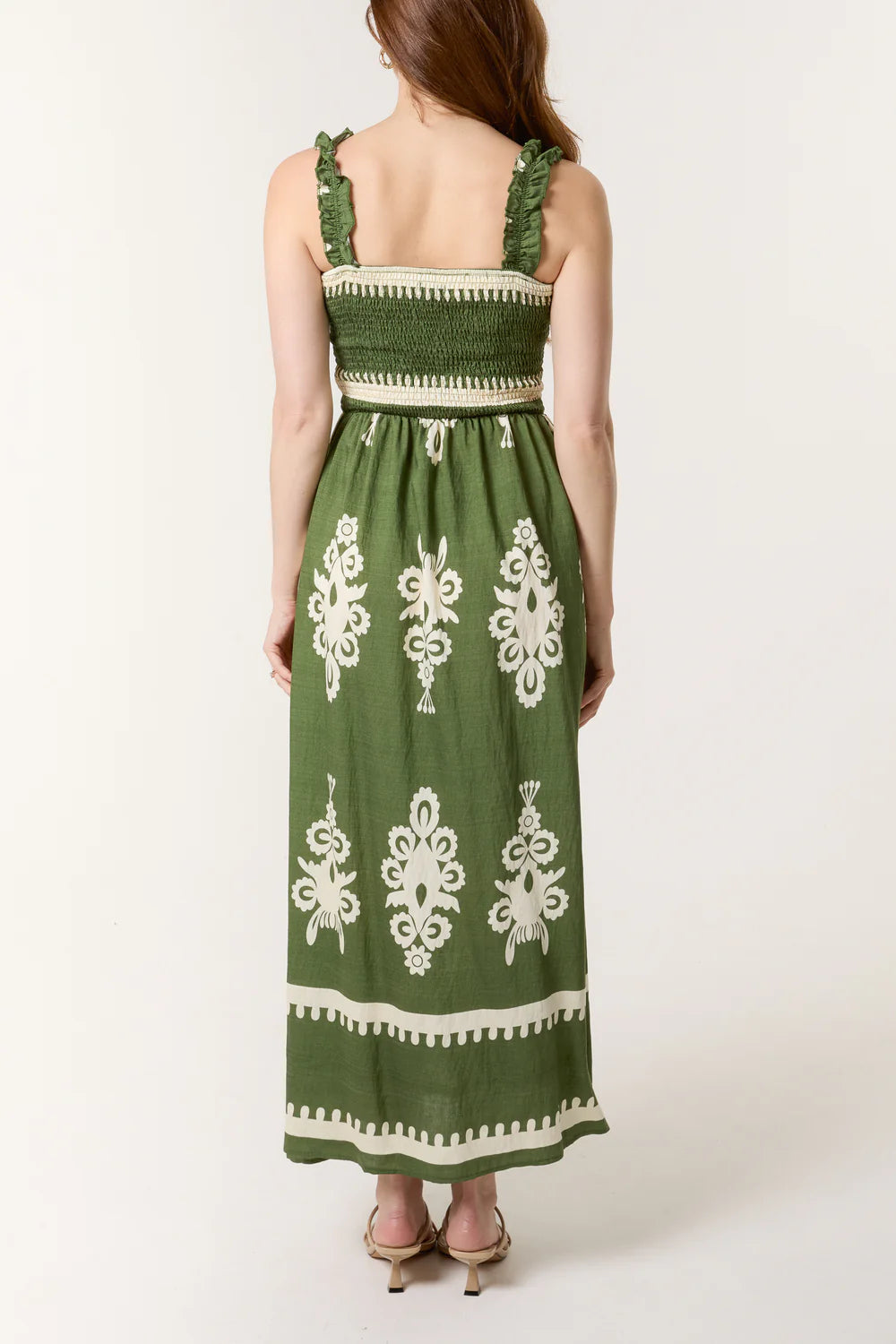 Flowy maxi dress with a shirred bodice and vibrant print, crafted from a soft viscose-polyester blend for breezy style.