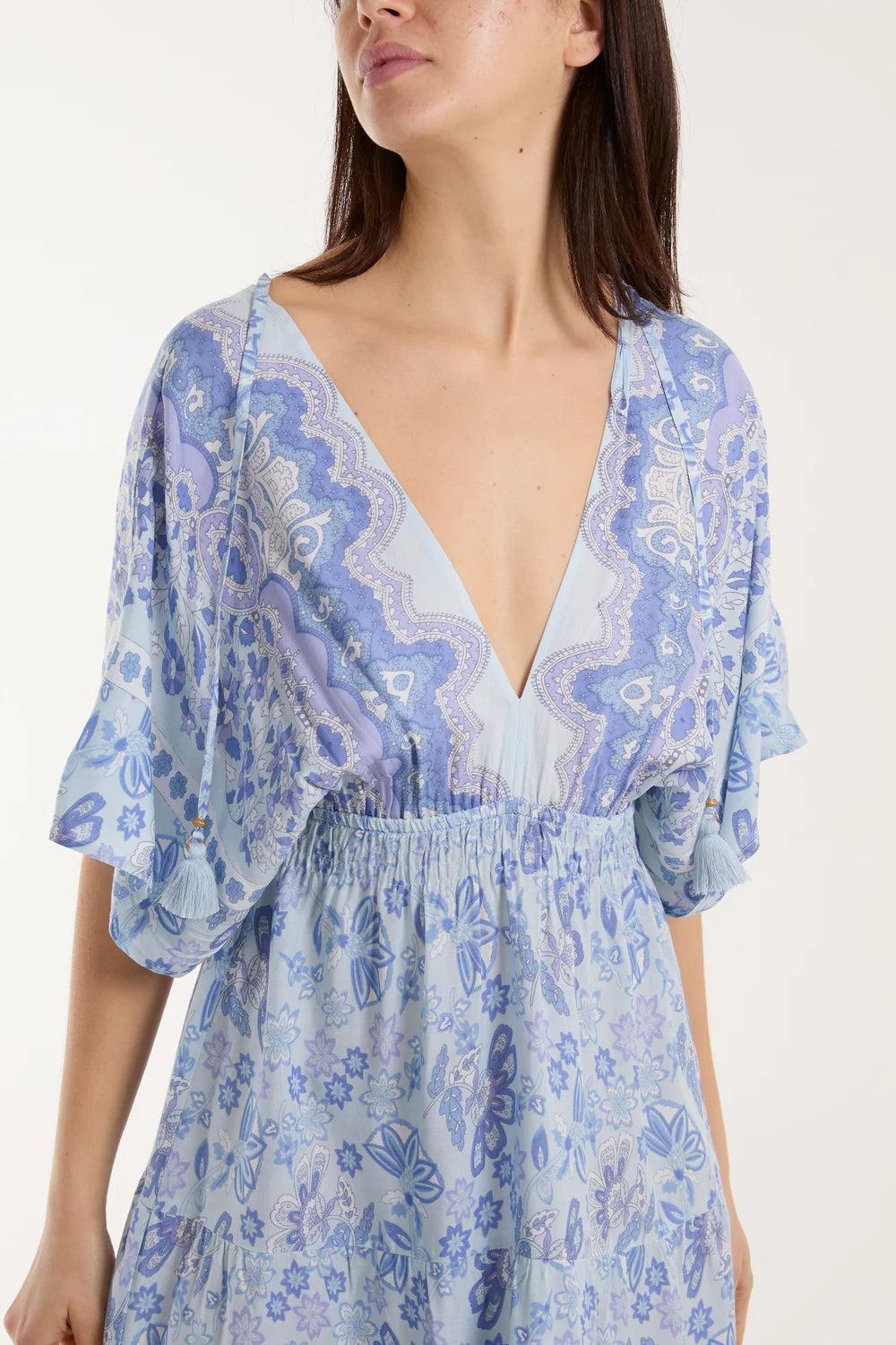 Flowing mixed print V-neck dress in vibrant colors with playful tassel details, crafted from 100% viscose for a breezy look.