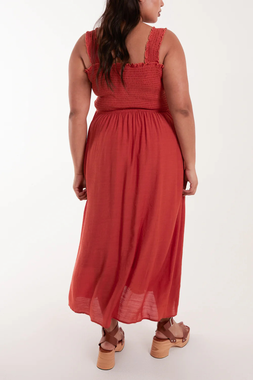 Elegant plus-size maxi dress with a shirred bust, thin straps, and stylish wooden buttons, perfect for summer outings.