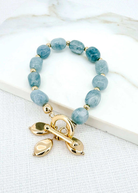 Envy - Gold and blue stone stretch bracelet with t-bar and charms