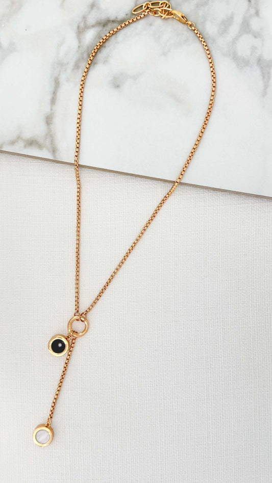 Envy - Gold necklace with black and white dropper pendant
