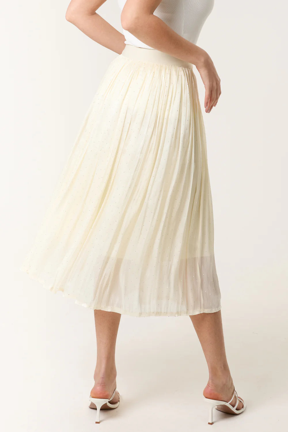 Elegant ivory midi skirt with a satin finish, elasticated waist, and subtle embellishments for a chic, flowing look.