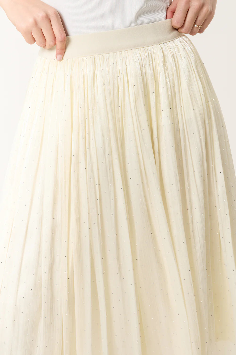 Elegant ivory midi skirt with a satin finish, elasticated waist, and subtle embellishments for a chic, flowing look.