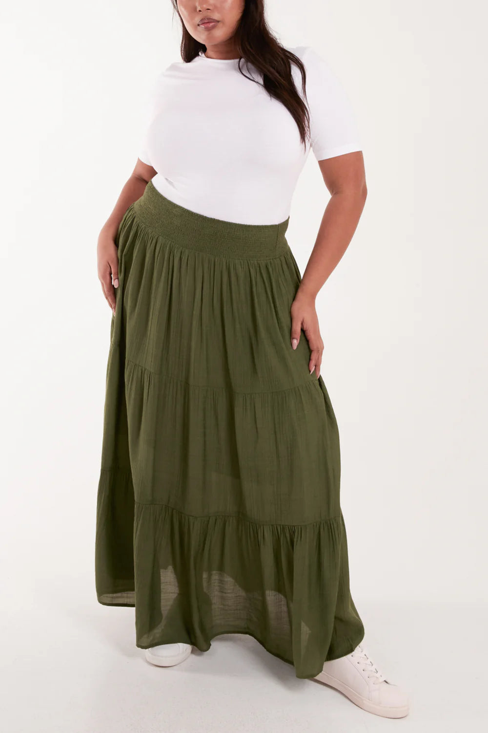 Flowy tiered maxi skirt in a shirred design, offering a flattering silhouette with a comfortable elastic waist for plus-size elegance.