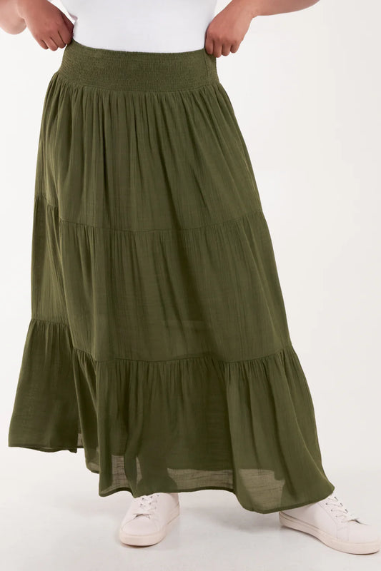 Flowy tiered maxi skirt in a lightweight fabric, featuring a shirred elastic waist for a comfy, flattering fit in plus sizes.