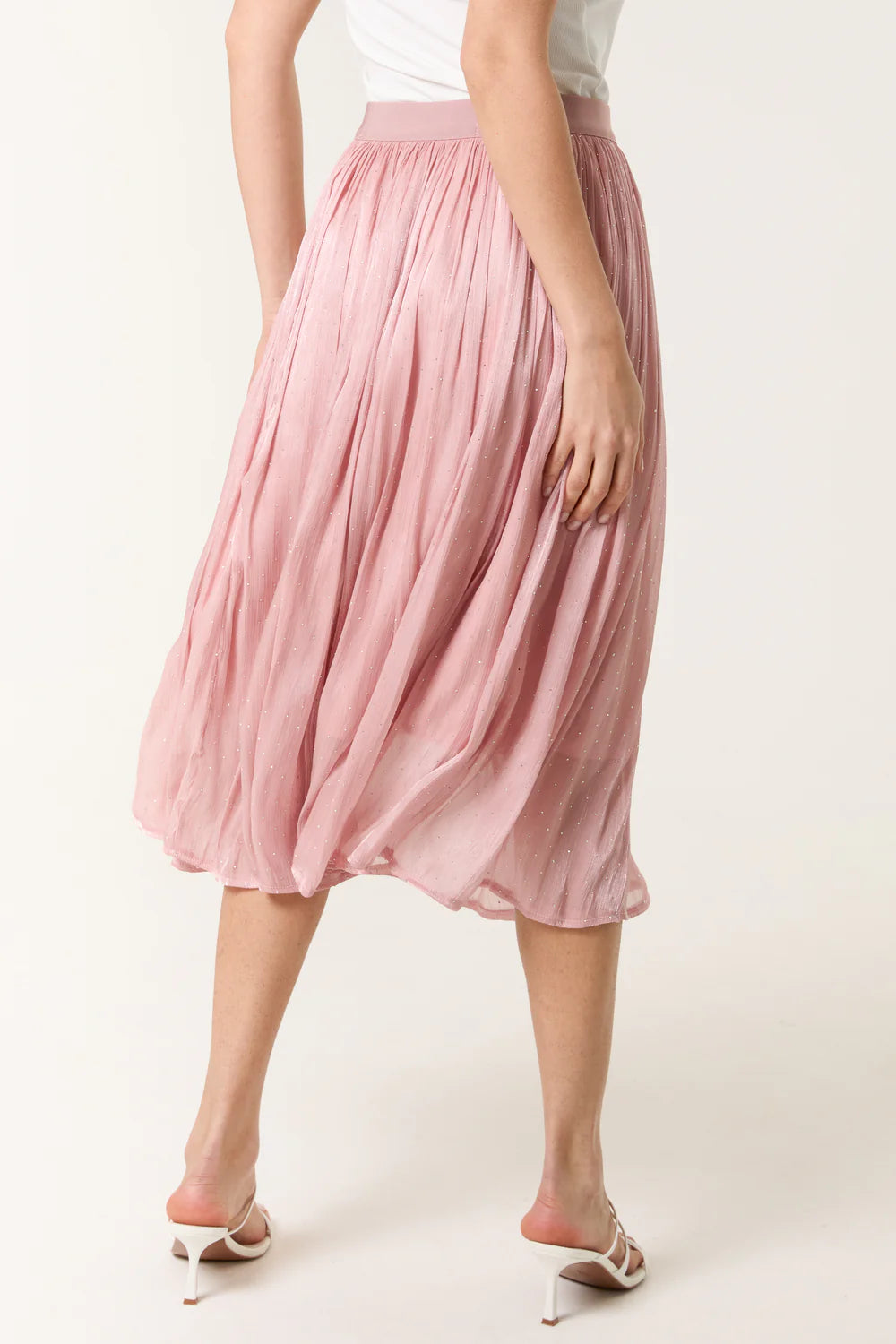 Flowing pink midi skirt with an elasticated waist and satin embellishments, offering a chic and comfortable style.