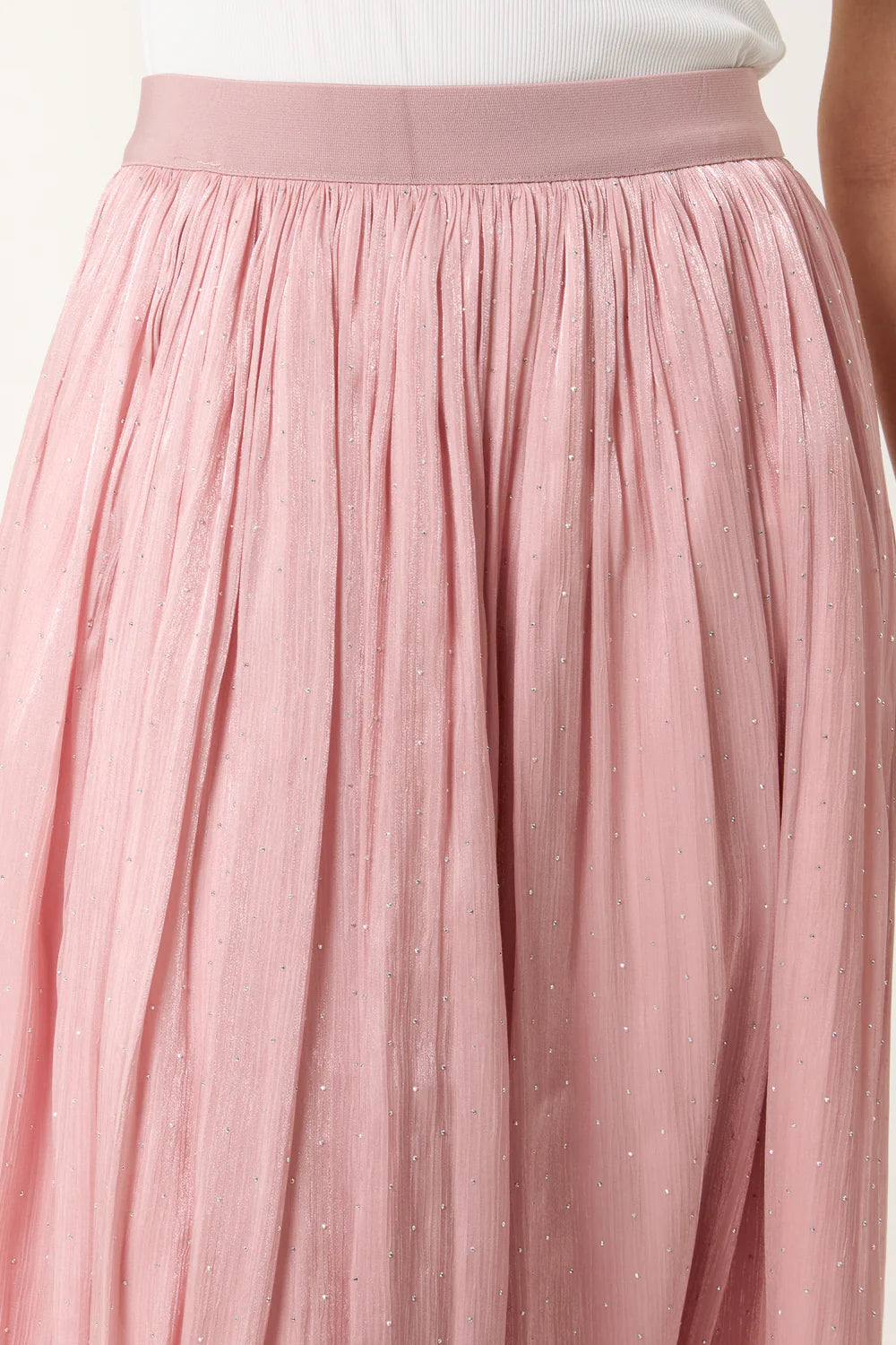 Flowing pink midi skirt with an elasticated waist and satin embellishments, offering a chic and comfortable style.