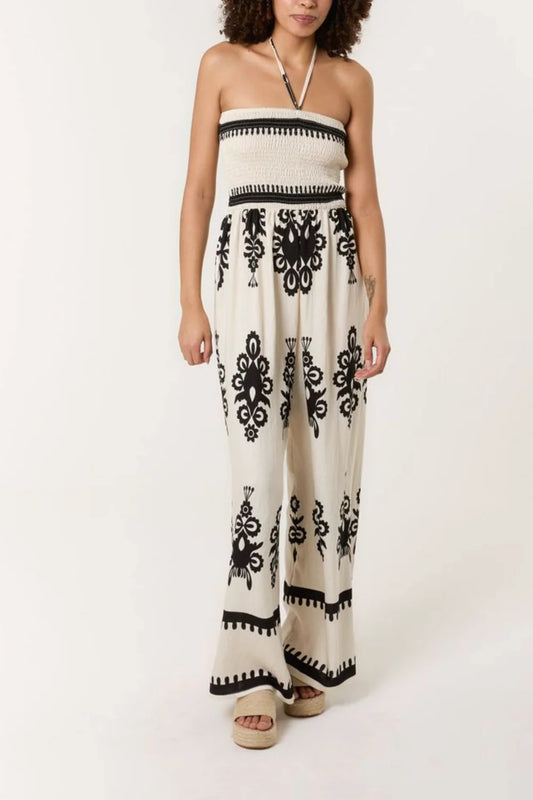 Vibrant printed jumpsuit in stone color with a shirred bodice and halterneck design, crafted from a soft viscose blend.
