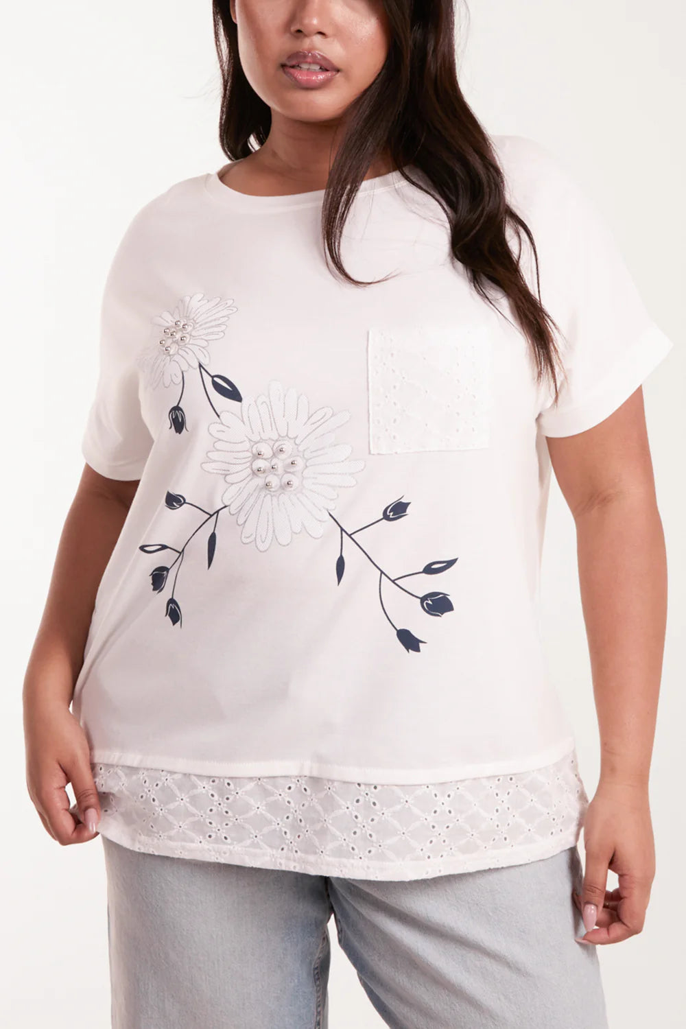 Charming white and blue flower top in size 18/20, showcasing a boxy fit with delicate broderie anglaise and floral embellishments.